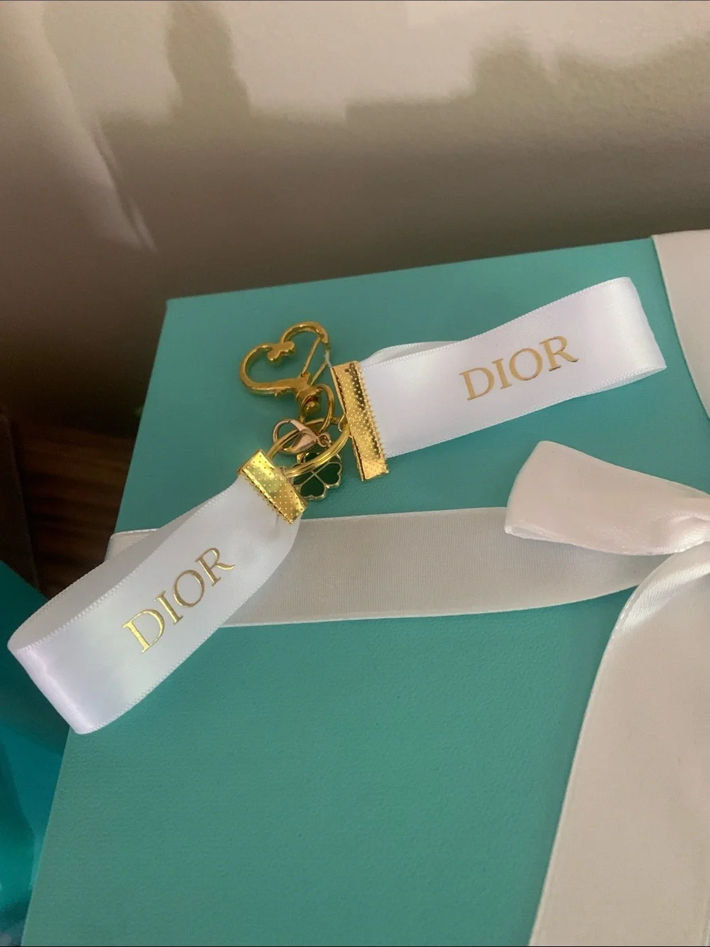 DIOR White Ribbon Key Ring with Gold & Green Clover Charm